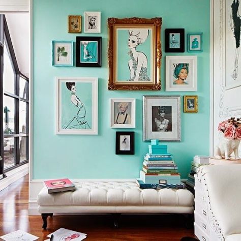 Create gallery walls with groups of artwork. Here the different-sized pictures hang together beautifully on the solid-coloured background wall. (dailydreamdecor.com)